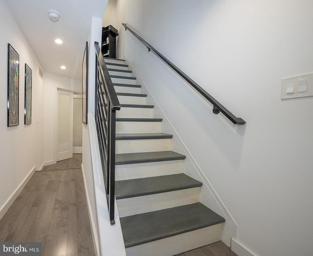 stairs with wood-type flooring