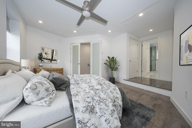 bedroom with ensuite bath, ceiling fan, and dark hardwood / wood-style floors