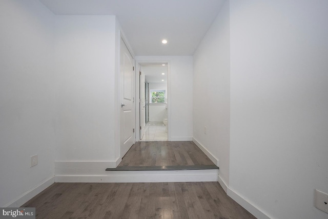 hallway with hardwood / wood-style flooring