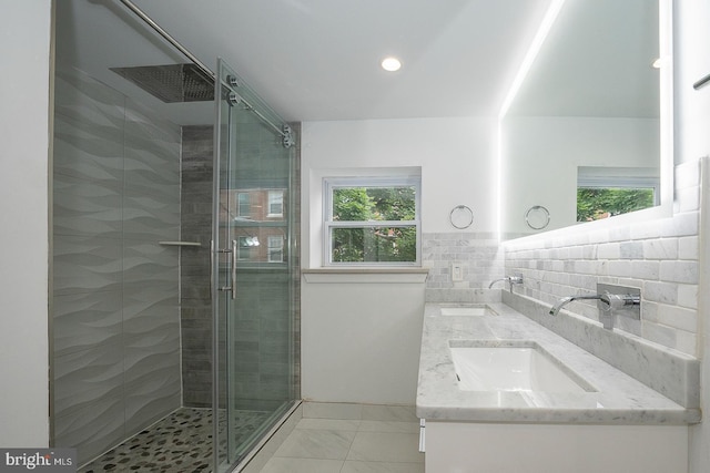 bathroom with tile patterned floors, vanity, decorative backsplash, and a shower with shower door