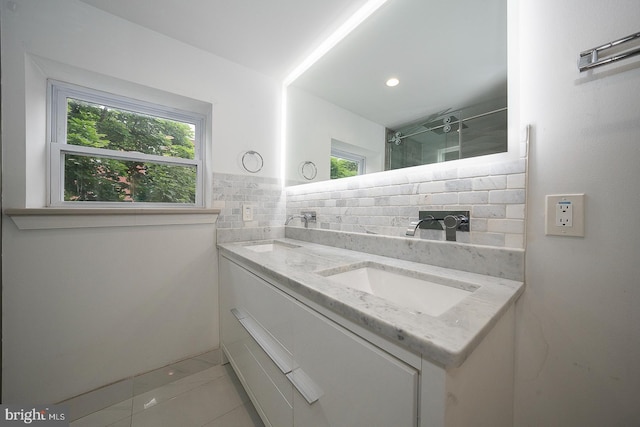 bathroom with tile patterned flooring, a shower, backsplash, and vanity