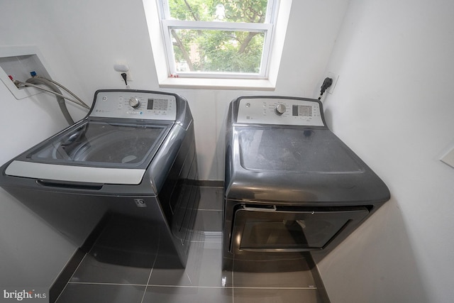 washroom with tile patterned flooring and washing machine and clothes dryer