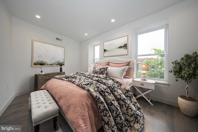 bedroom with dark hardwood / wood-style flooring