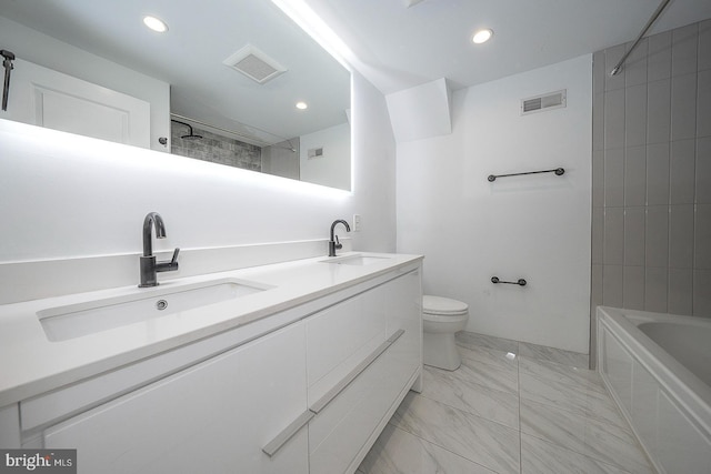 full bathroom with tiled shower / bath combo, vanity, and toilet