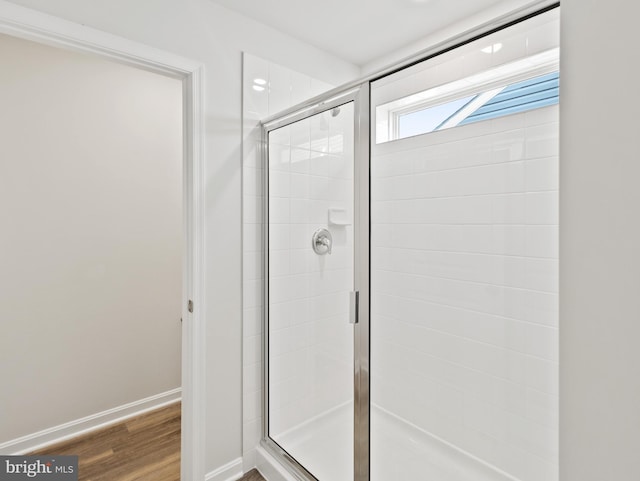 bathroom with hardwood / wood-style floors and walk in shower