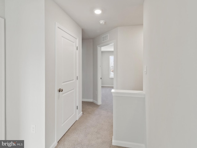 hallway featuring light carpet