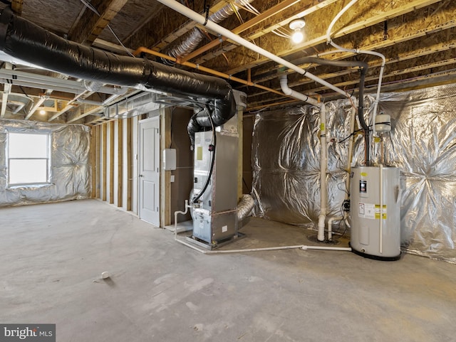 basement featuring electric water heater and heating unit