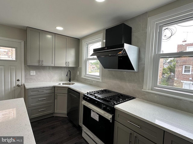 kitchen featuring gray cabinets, decorative backsplash, black appliances, wall chimney exhaust hood, and sink