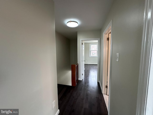 hall featuring a baseboard heating unit and dark hardwood / wood-style flooring