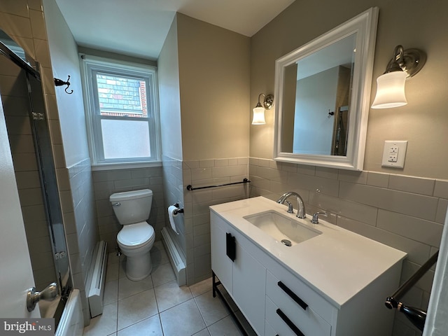 bathroom featuring toilet, vanity, tile walls, and tile patterned floors