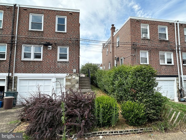 view of front facade featuring cooling unit and a garage