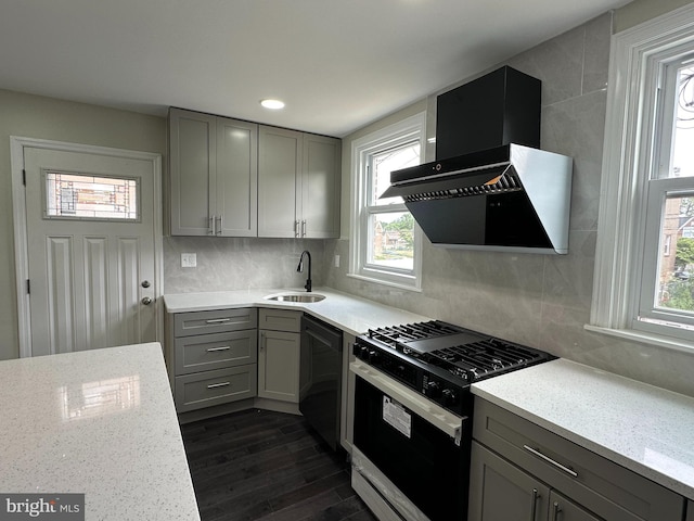 kitchen featuring gray cabinetry, black appliances, backsplash, wall chimney exhaust hood, and sink