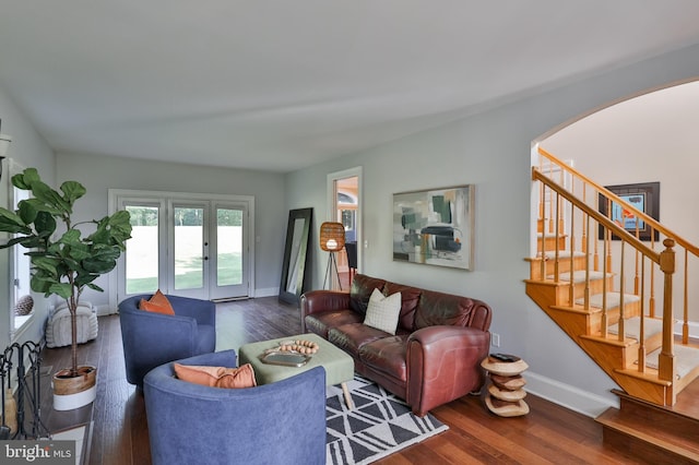 living room featuring french doors and dark wood-type flooring