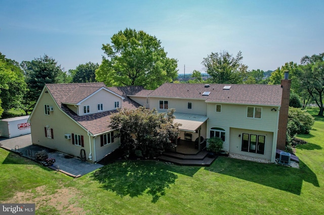 back of house featuring a wooden deck and a yard