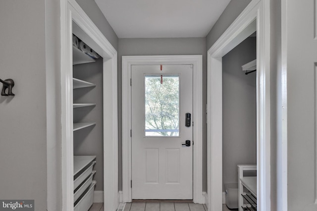 doorway to outside with light tile patterned floors