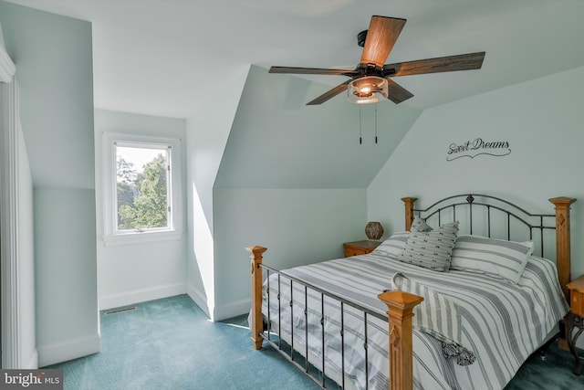 carpeted bedroom with ceiling fan and vaulted ceiling