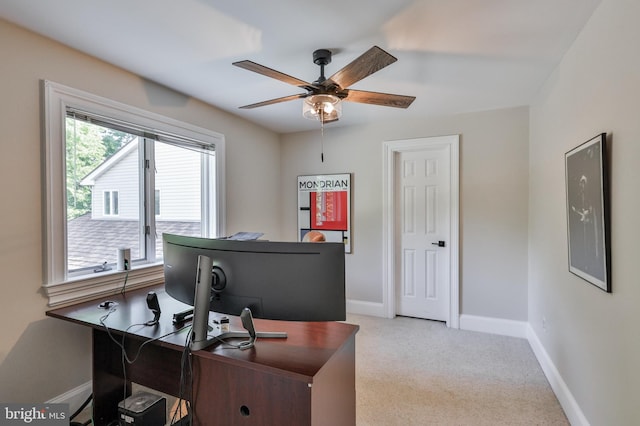 carpeted home office with ceiling fan