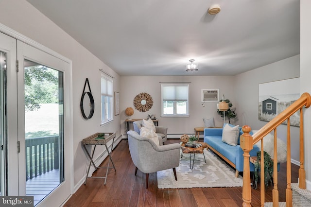 living room featuring a baseboard heating unit, dark wood-type flooring, and a wall unit AC