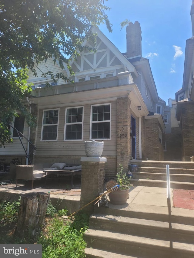 view of front of property featuring outdoor lounge area and a patio area