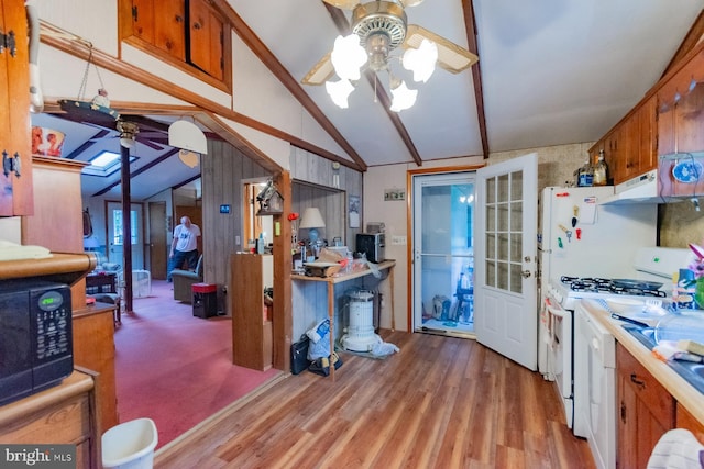 kitchen with ceiling fan, lofted ceiling with beams, white gas stove, and light wood-type flooring