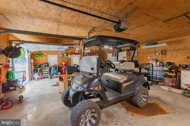 garage featuring a garage door opener and a workshop area