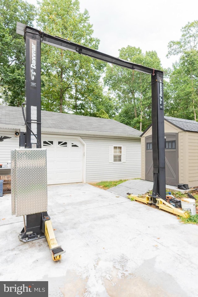 view of property exterior with a garage and a shed