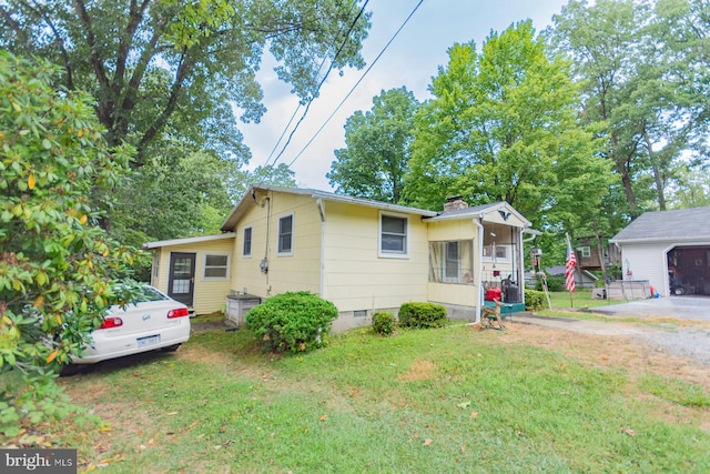 bungalow-style home with a front lawn