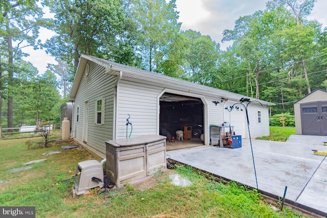 view of property exterior featuring a garage and a storage unit