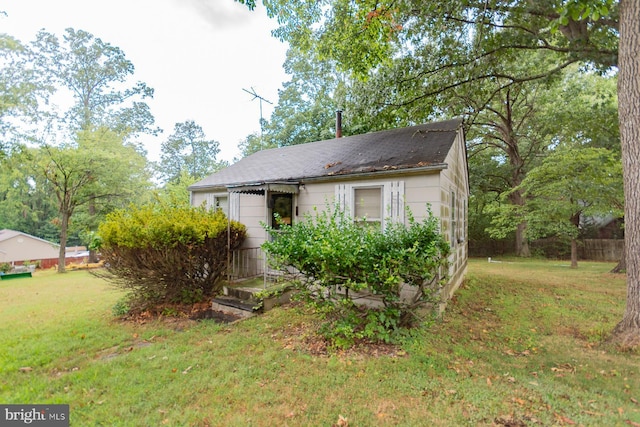 bungalow-style home featuring a front yard