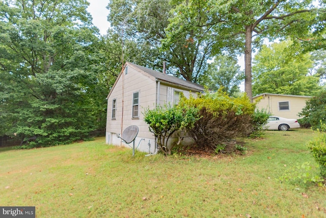 view of property exterior with a lawn