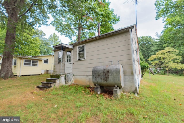 rear view of house featuring a yard