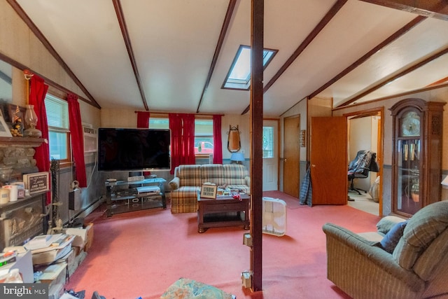 carpeted living room featuring vaulted ceiling with skylight