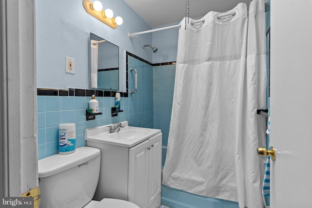 full bathroom with toilet, tile walls, shower / bath combo, and vanity