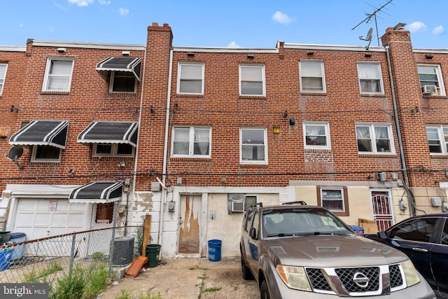 rear view of property with cooling unit and central AC