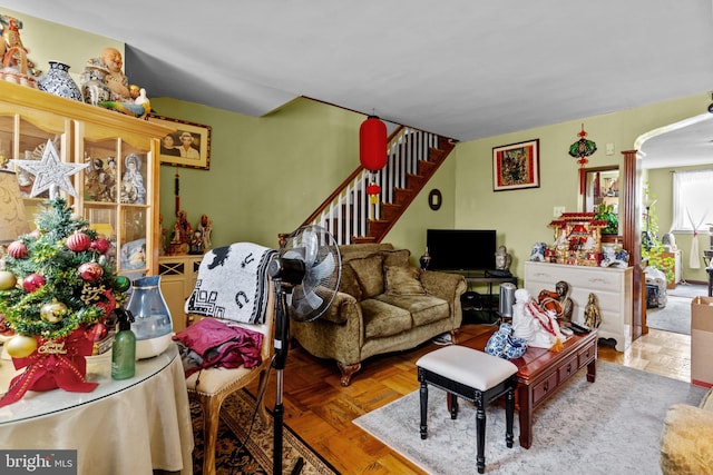 living room featuring parquet floors and decorative columns