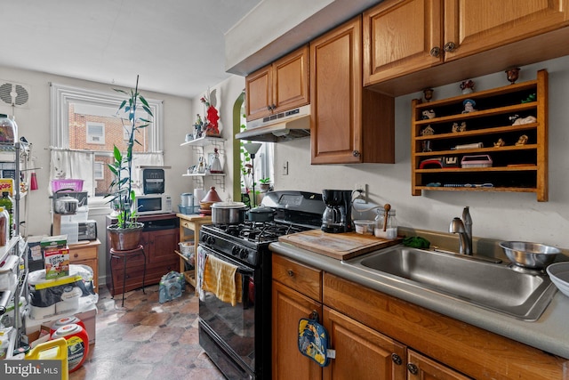 kitchen featuring black gas range oven and sink