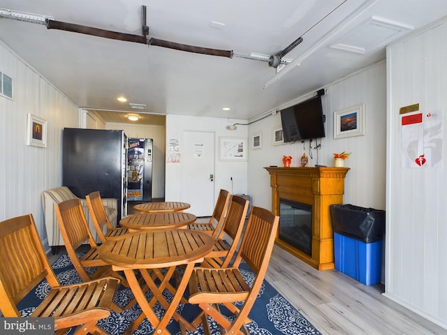 dining space with light hardwood / wood-style floors