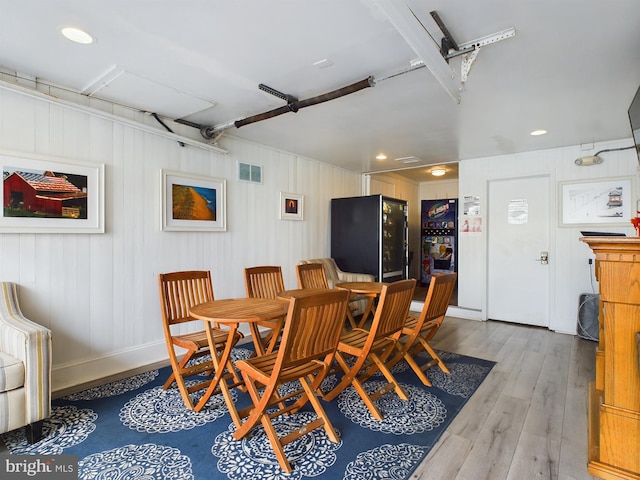 dining space with light hardwood / wood-style floors