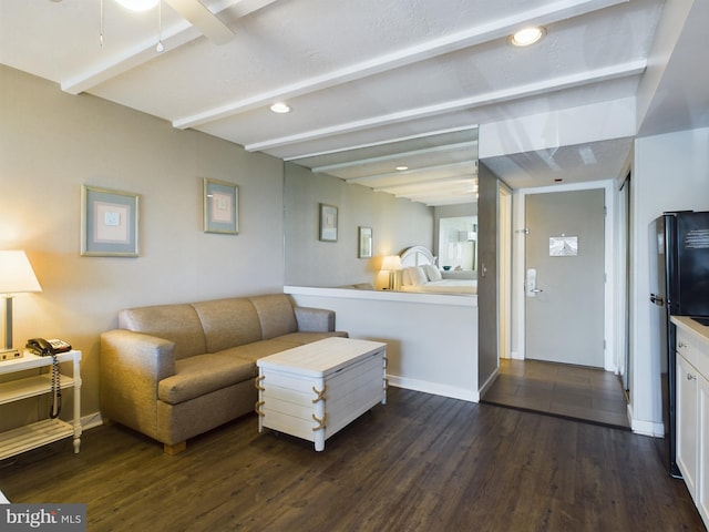 living room with beamed ceiling, dark hardwood / wood-style floors, and ceiling fan