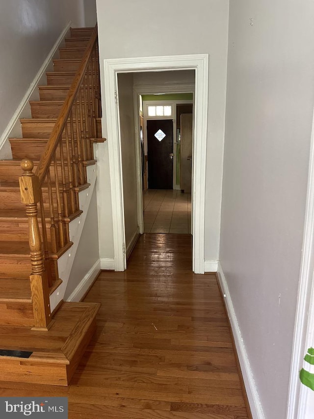 corridor with hardwood / wood-style flooring