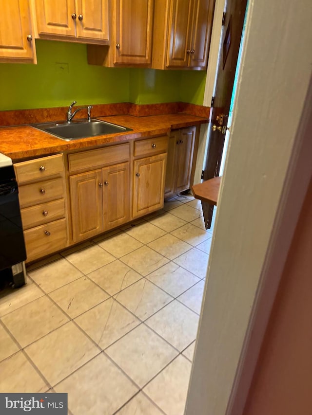 kitchen featuring sink and light tile patterned floors