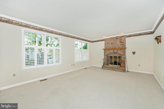 unfurnished living room featuring crown molding, plenty of natural light, and a fireplace