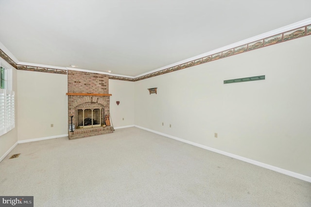 unfurnished living room featuring carpet, a fireplace, and brick wall