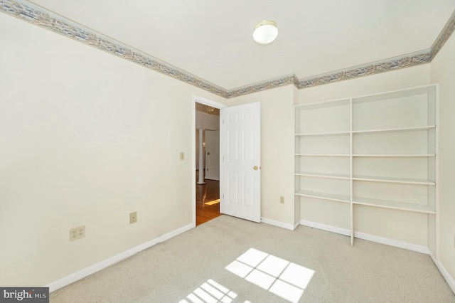 unfurnished bedroom with a closet and light carpet