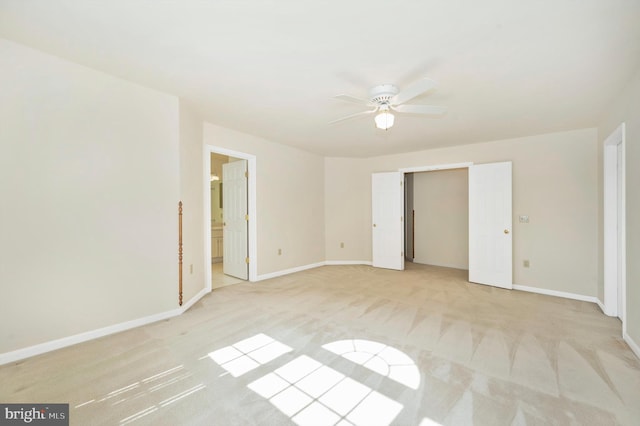 unfurnished bedroom with ceiling fan and light colored carpet