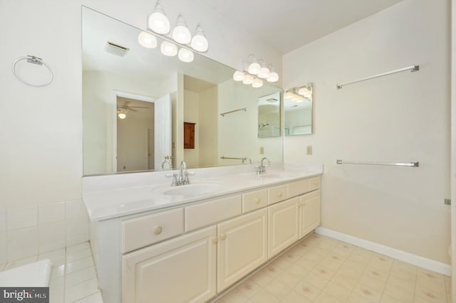 bathroom with tile patterned flooring, ceiling fan, and vanity