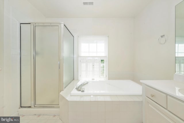 bathroom featuring tile patterned flooring, separate shower and tub, and vanity