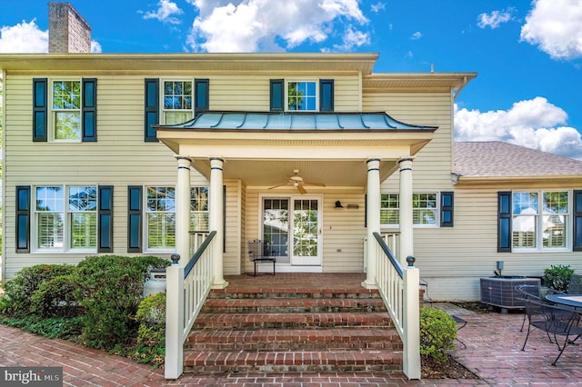 view of front of property with ceiling fan, central AC, and a porch