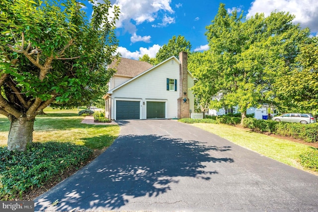 view of property exterior with a lawn and a garage