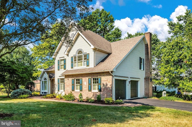 front facade with a garage and a front yard